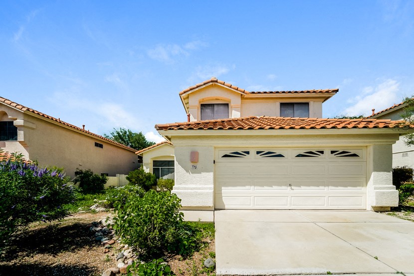 a house with a white garage door and a driveway