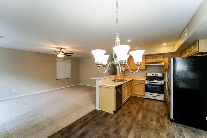 a kitchen and dining room with wood flooring and a chandelier