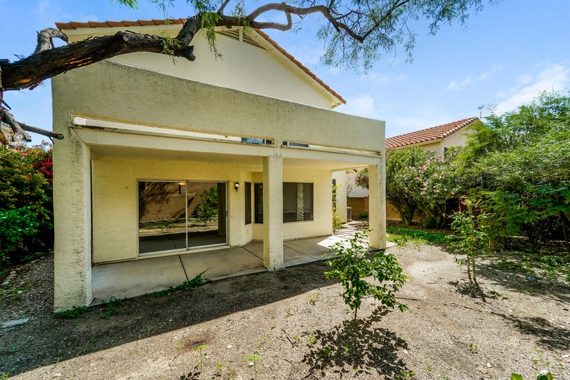 a white house with a tree in front of it