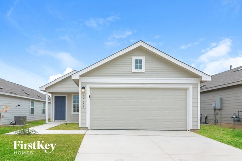 a beige and white house with a garage door