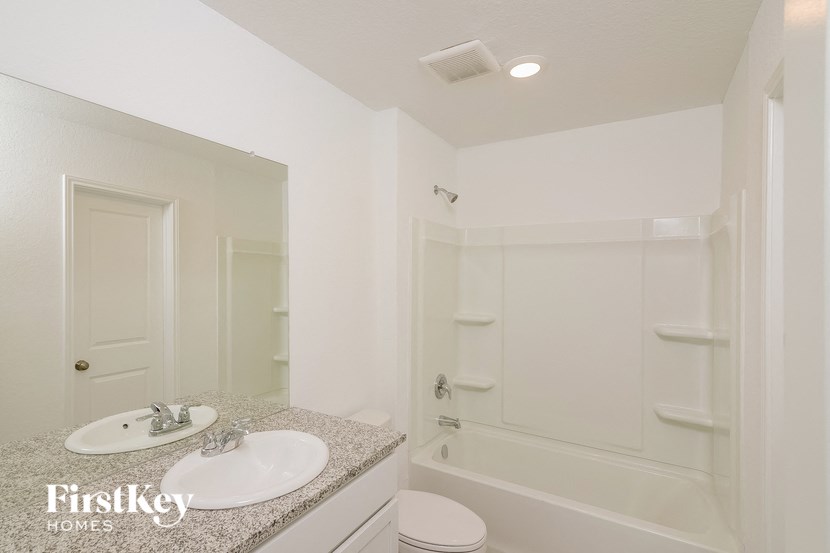 a bathroom with a sink and a shower and a toilet