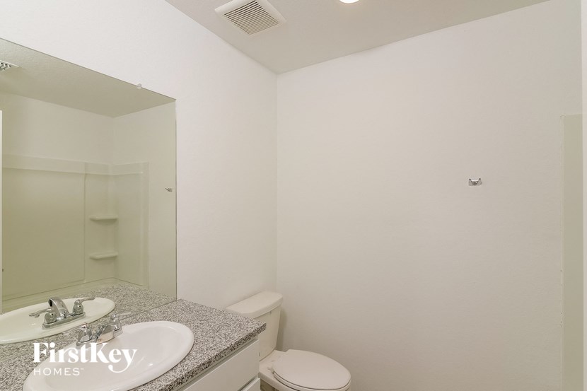 a bathroom with a sink and a toilet and a mirror