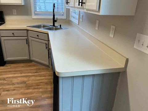 A kitchen with a sink and a window.