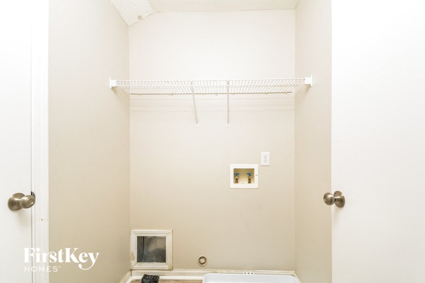 a bathroom with a shower and a toilet and a white wall