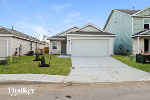 the front yard of a house with a driveway and a lawn