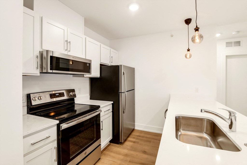 a kitchen with stainless steel appliances and white cabinets