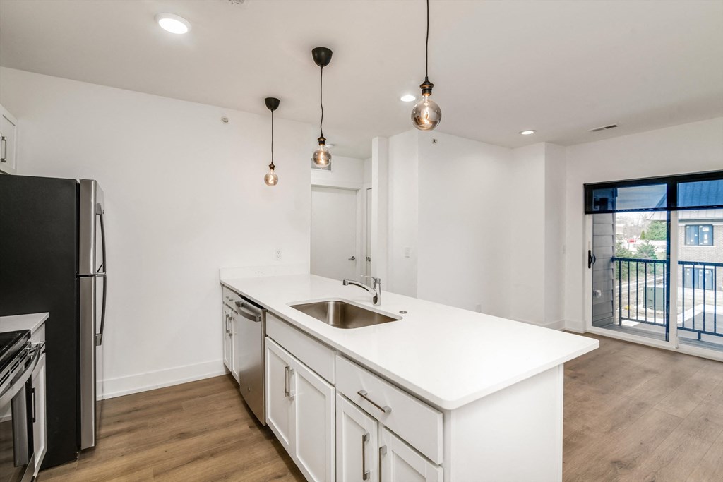 a renovated kitchen with white cabinets and a white counter top