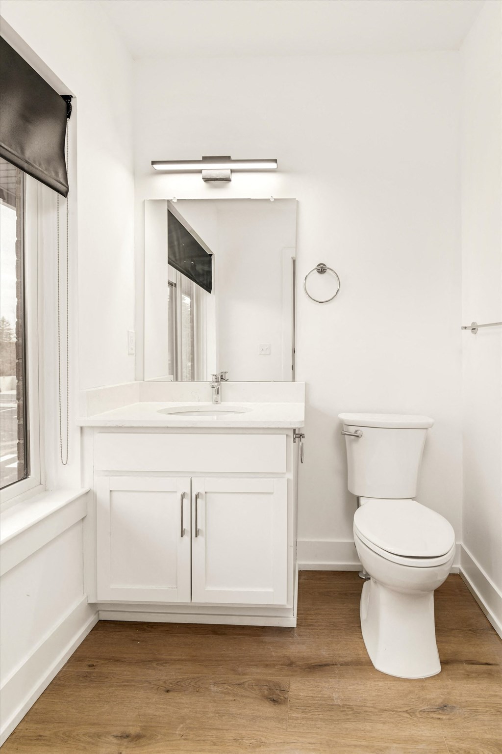 a white bathroom with a toilet and a sink