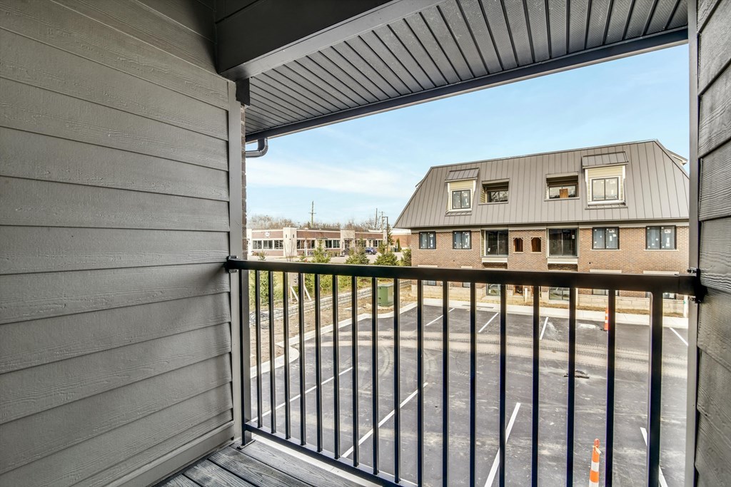 a balcony with a view of a building and a gate