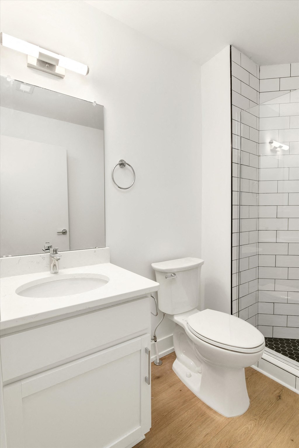 a white bathroom with a toilet and a sink