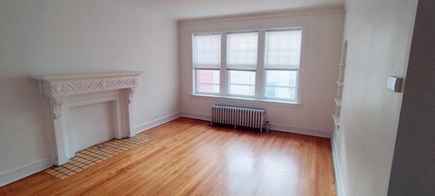 a living room with a fireplace and a window