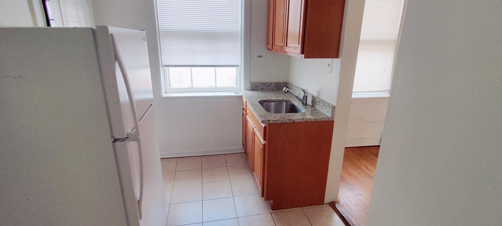 a kitchen with a sink and a refrigerator