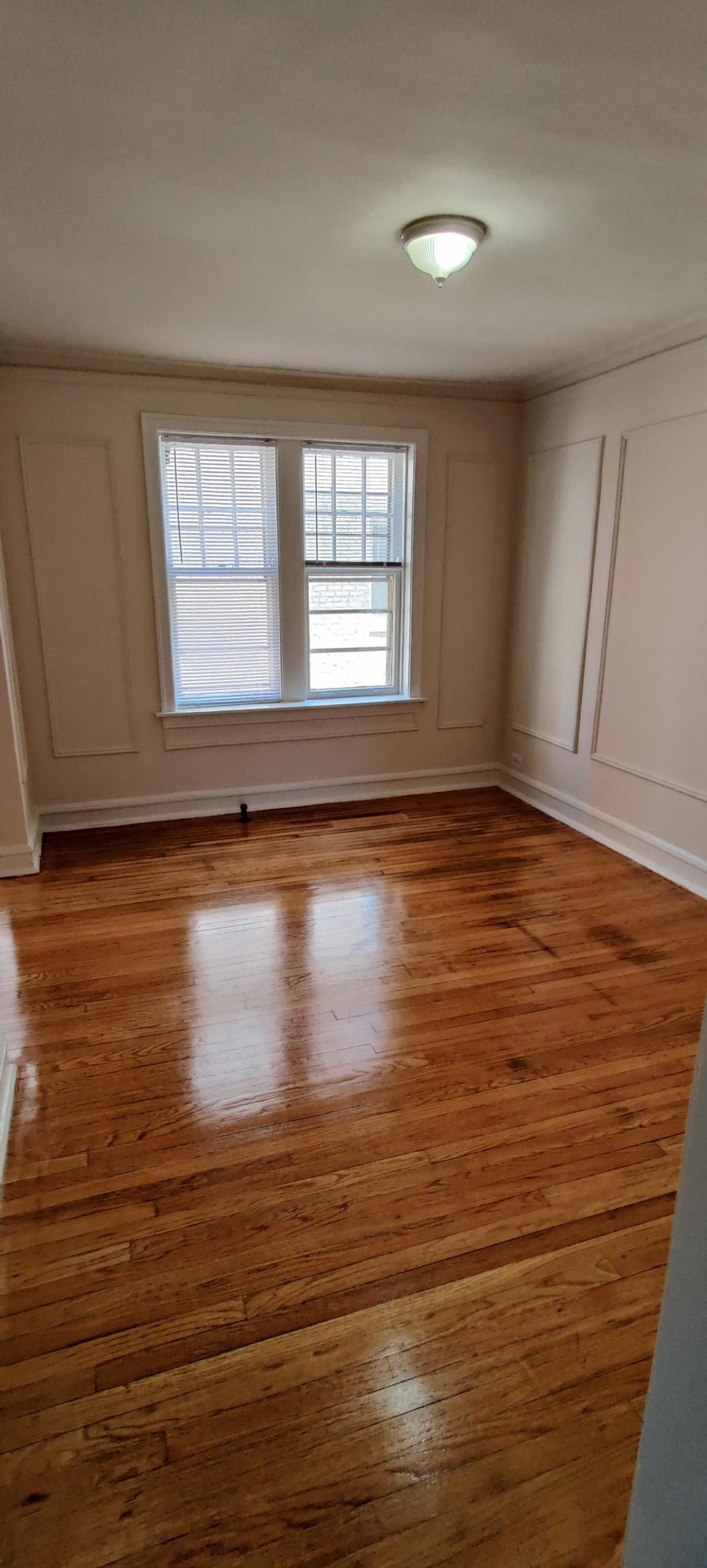 the living room of an empty house with wooden floors