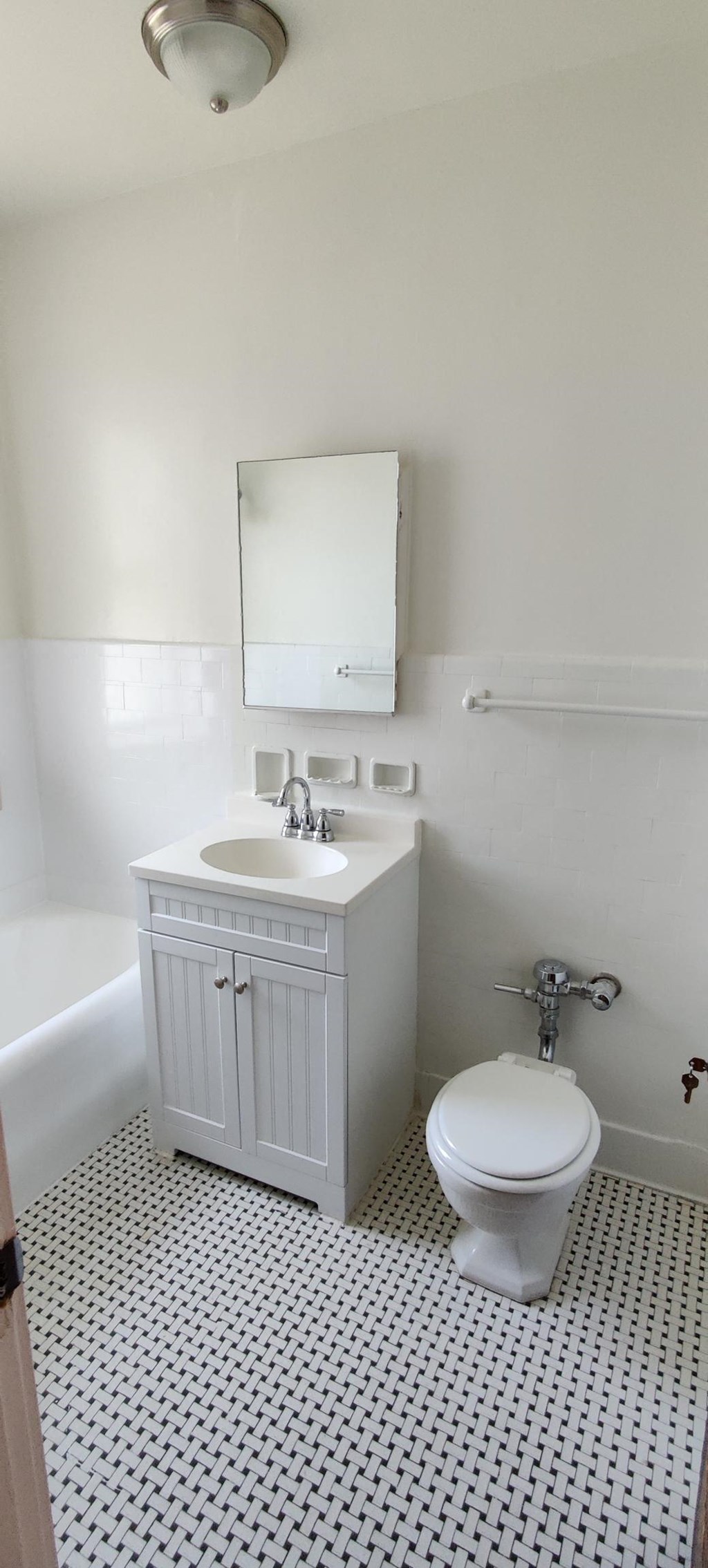 a white bathroom with a sink toilet and bath tub