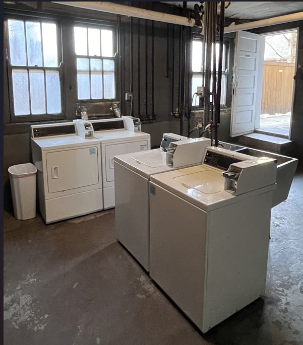 A white sink is in a room with a window.