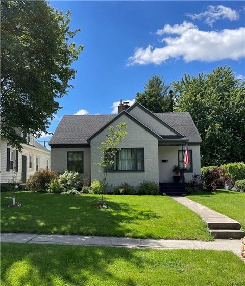 a white house with a lawn in front of it