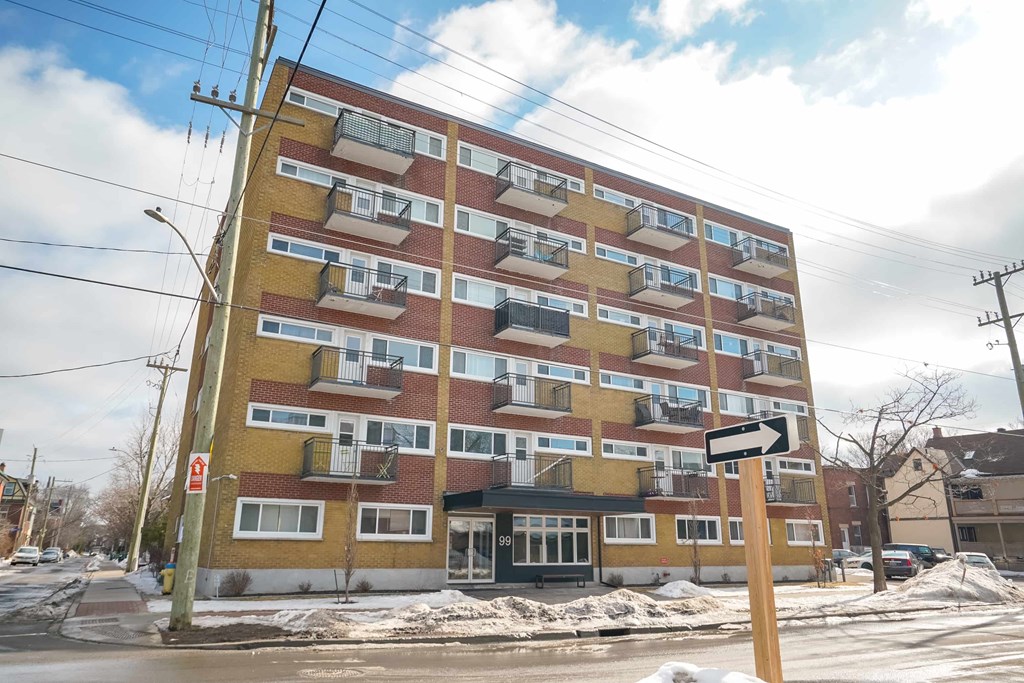 A large multi-story building with a yellow and red facade.