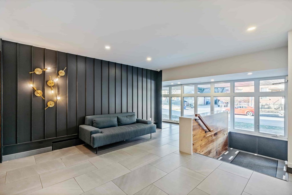A modern living room with a grey sofa and a wooden coffee table.