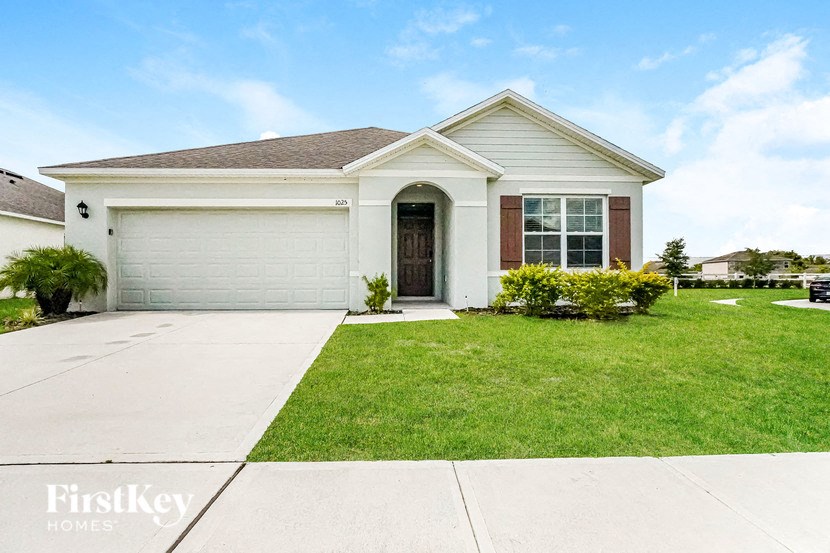 A house with a brown roof and a white garage door is for sale.