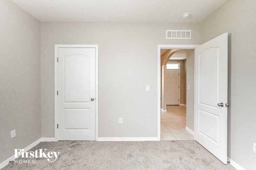 A white door is on the left and a white door is on the right.