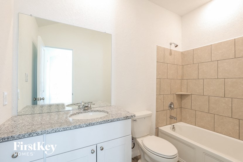 a bathroom with a sink toilet and a bath tub