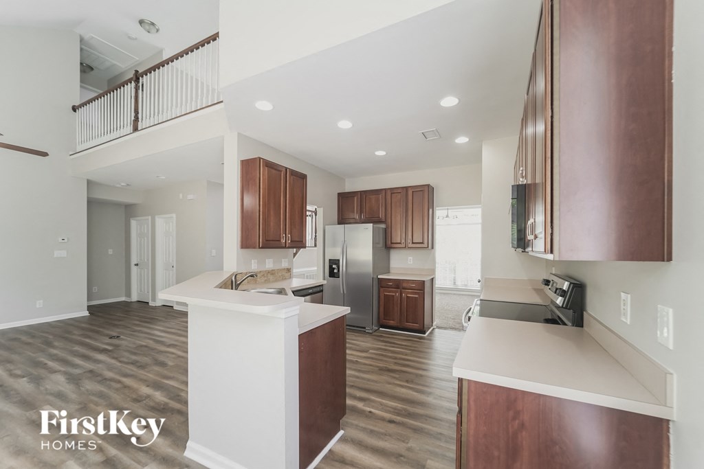 A modern kitchen with wooden cabinets and a white island.