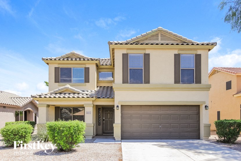 A two-story house with a garage is shown in the image.