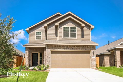 A house with a garage door is for sale.