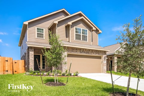 A house with a brown garage door and a brown fence.