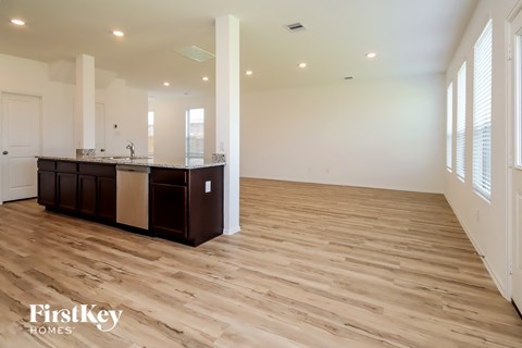 A spacious kitchen with wooden floors and a central island.