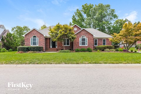 a brick house with a lawn in front of it