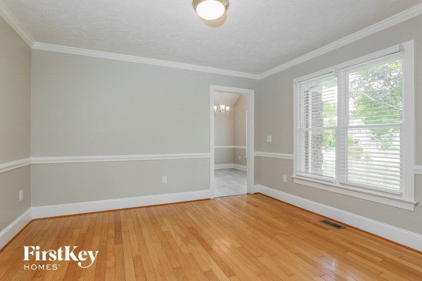 the living room and dining room of a house with wood floors