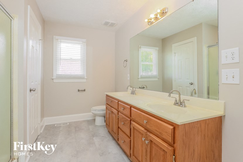 a bathroom with a sink and a toilet and a mirror
