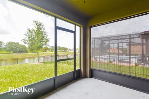 a living room with large windows and a view of a park