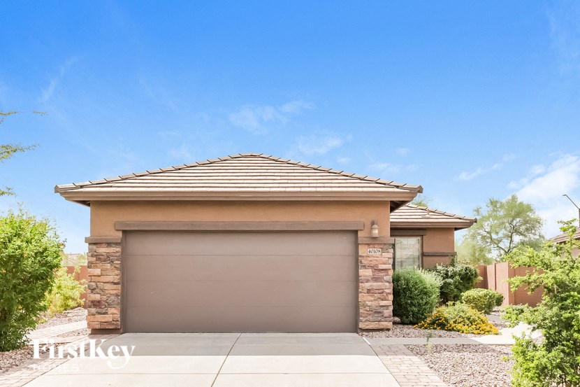 A house with a brown garage door and a stone pillar.