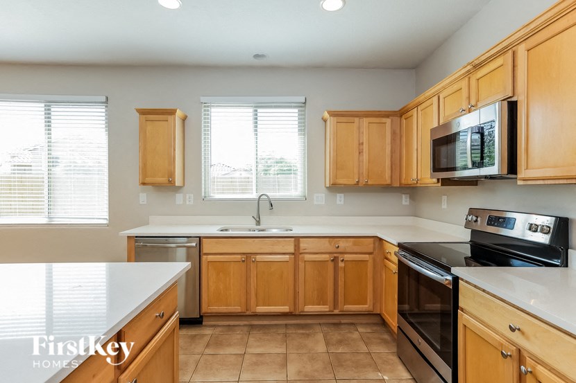 A kitchen with wooden cabinets and a white countertop.
