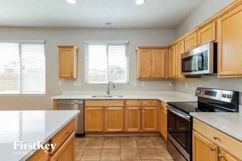 A kitchen with wooden cabinets and a white countertop.