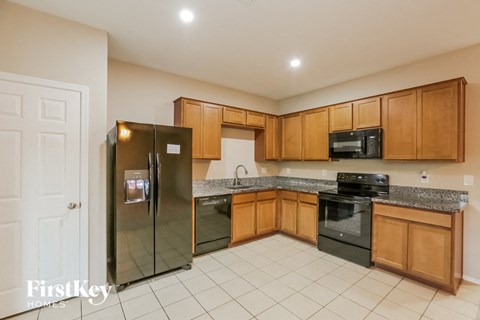 a kitchen with wooden cabinets and stainless steel appliances
