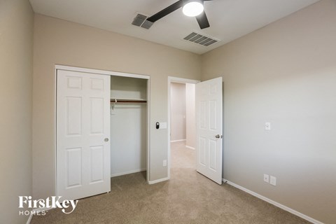 a bedroom with two closets and a door to a closet