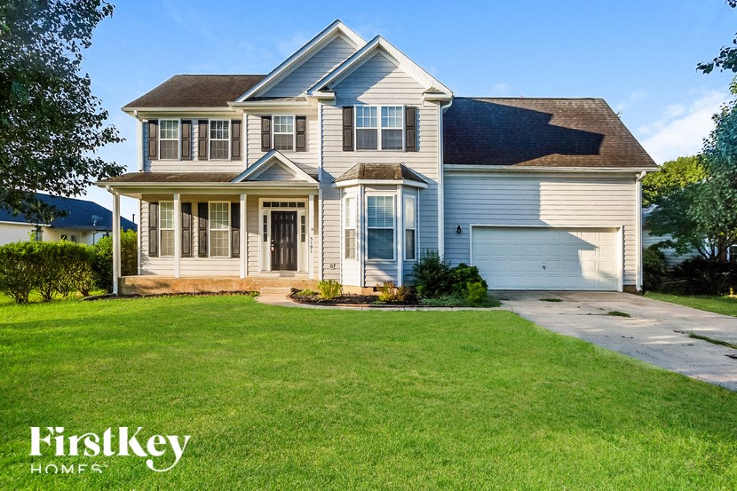 a white house with a lawn in front of it