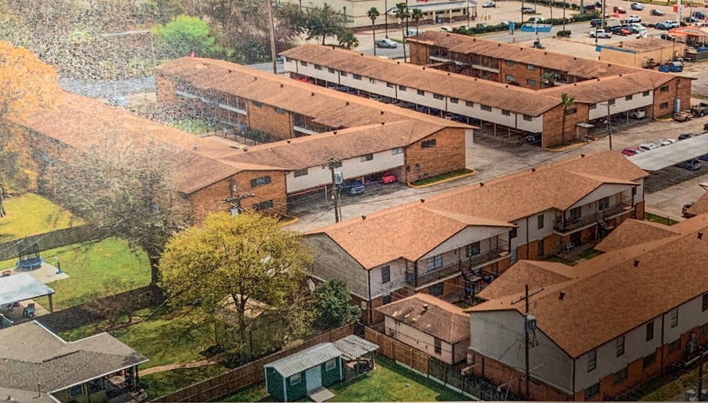 an aerial view of a group of buildings with roofs