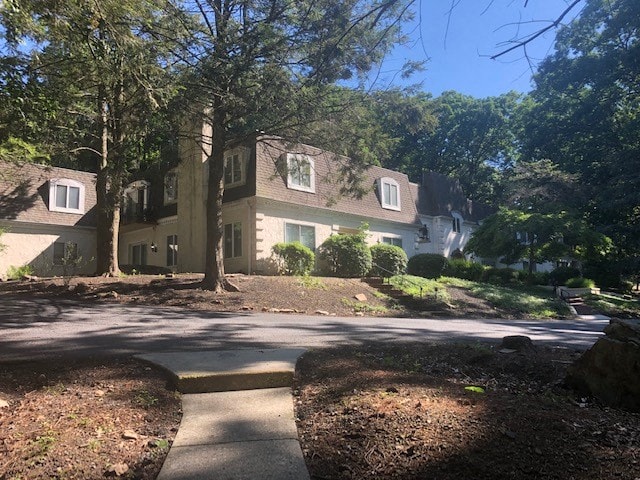 A large house with a driveway in front of it.