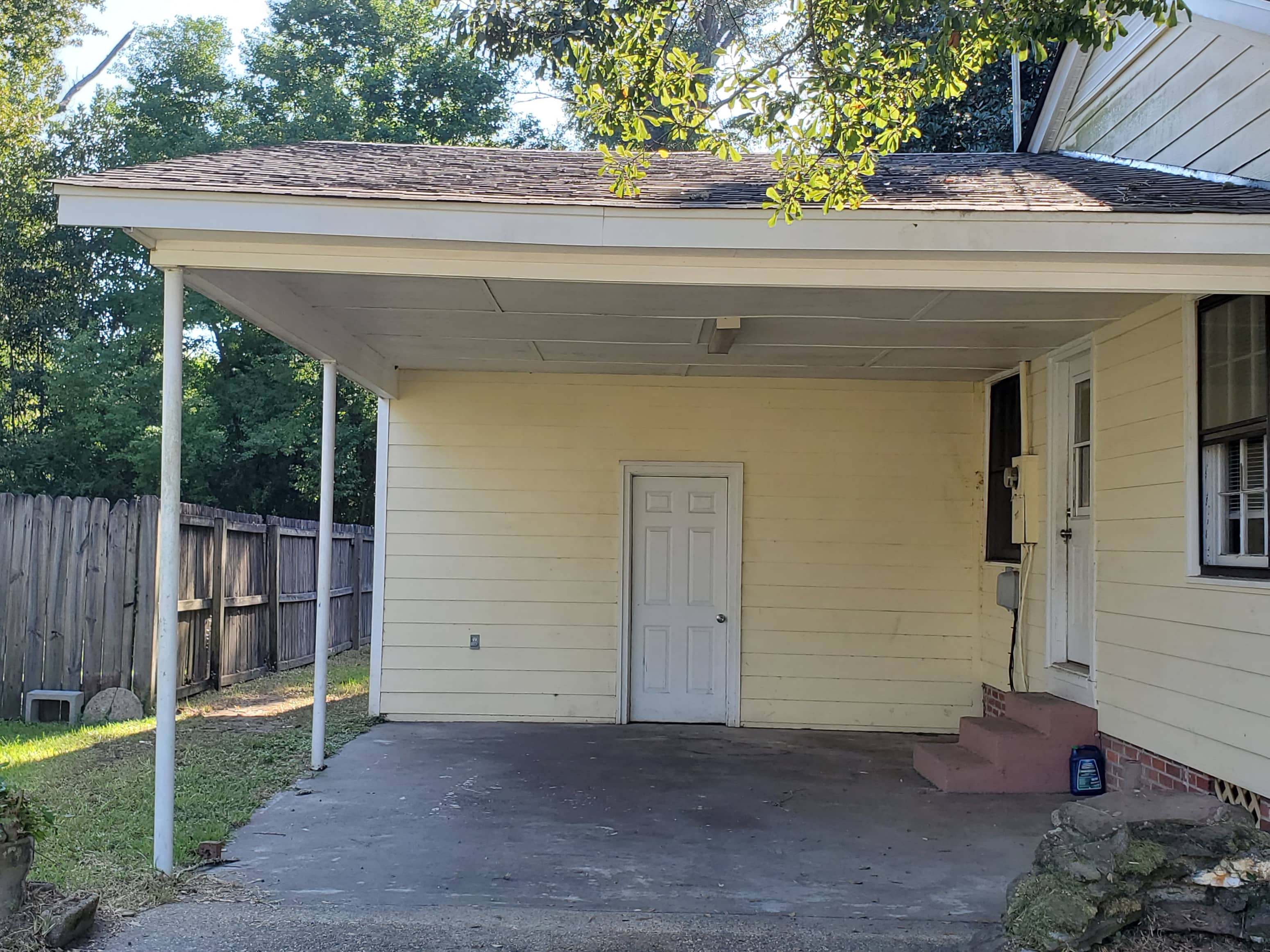 A small house with a white door and a porch.