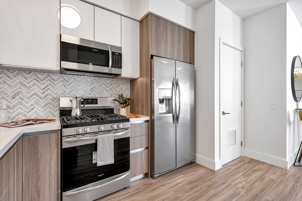 a kitchen with stainless steel appliances and a refrigerator