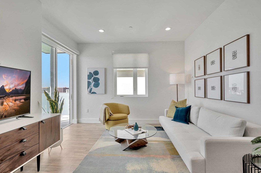 a living room with a white couch and a tv