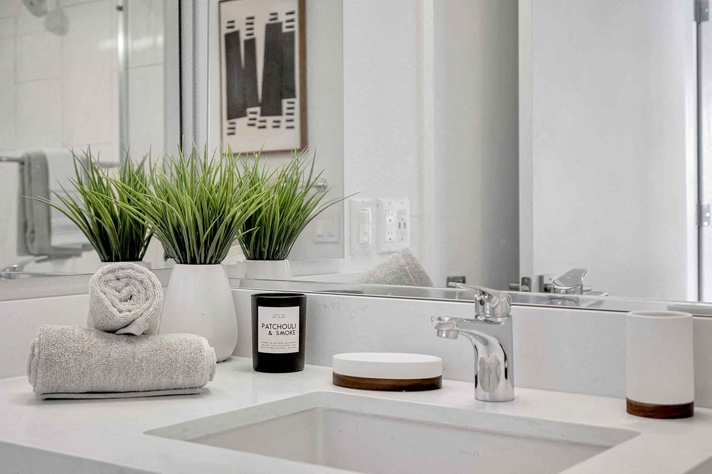 a white bathroom with a sink and a mirror