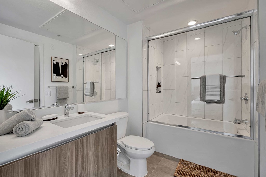 a bathroom with a shower and a sink and a toilet