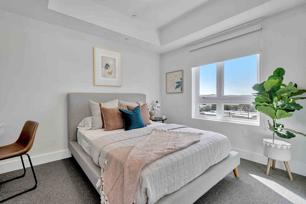 a bedroom with a bed and a window