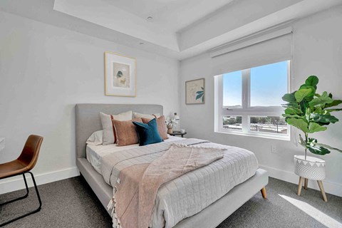 a bedroom with a bed and a window