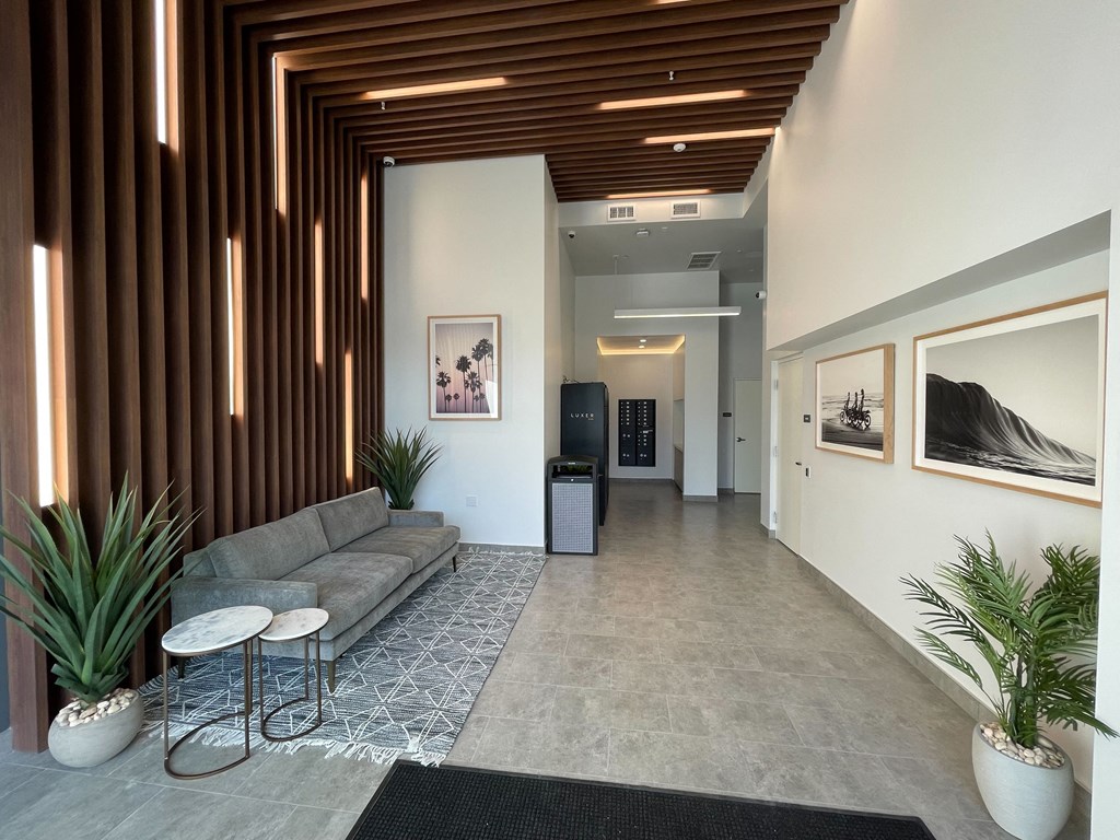 a living room with a couch and tables in a lobby